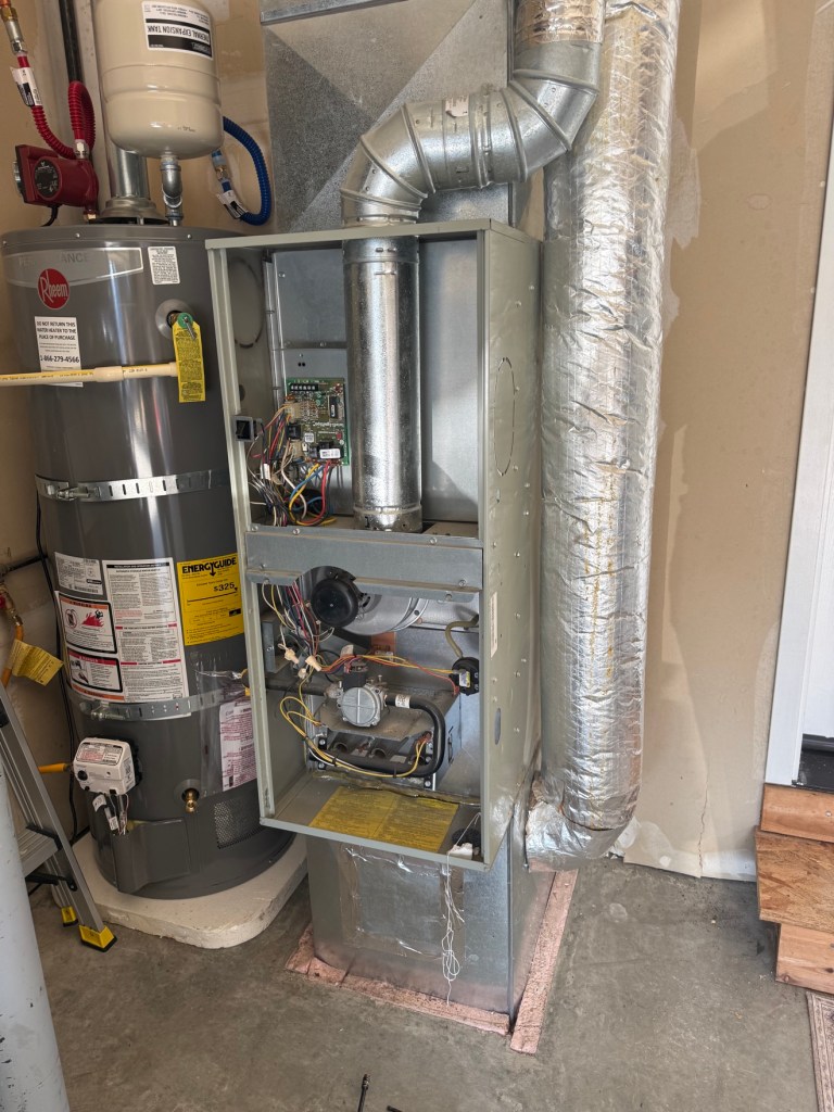 Old furnace without cover before replacement